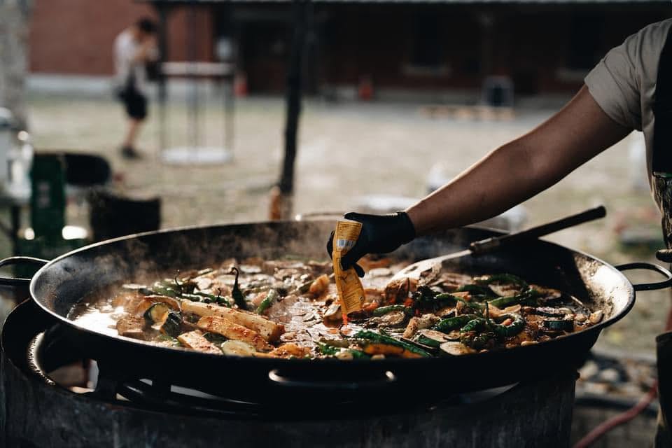 Spanish seafood paella made with Yimi Parboiled Rice, demonstrating its use in commercial food service applications.